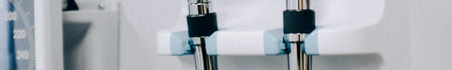 Medical examination tools including a stethoscope and otoscope mounted on a wall.